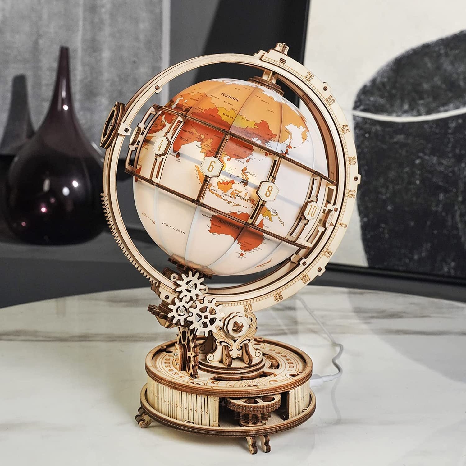 Wooden globe with mechanical design on a marble surface