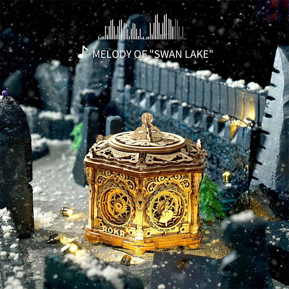 Decorative gold box with intricate designs in a snowy, castle-like setting with 'Melody of Swan Lake' text.