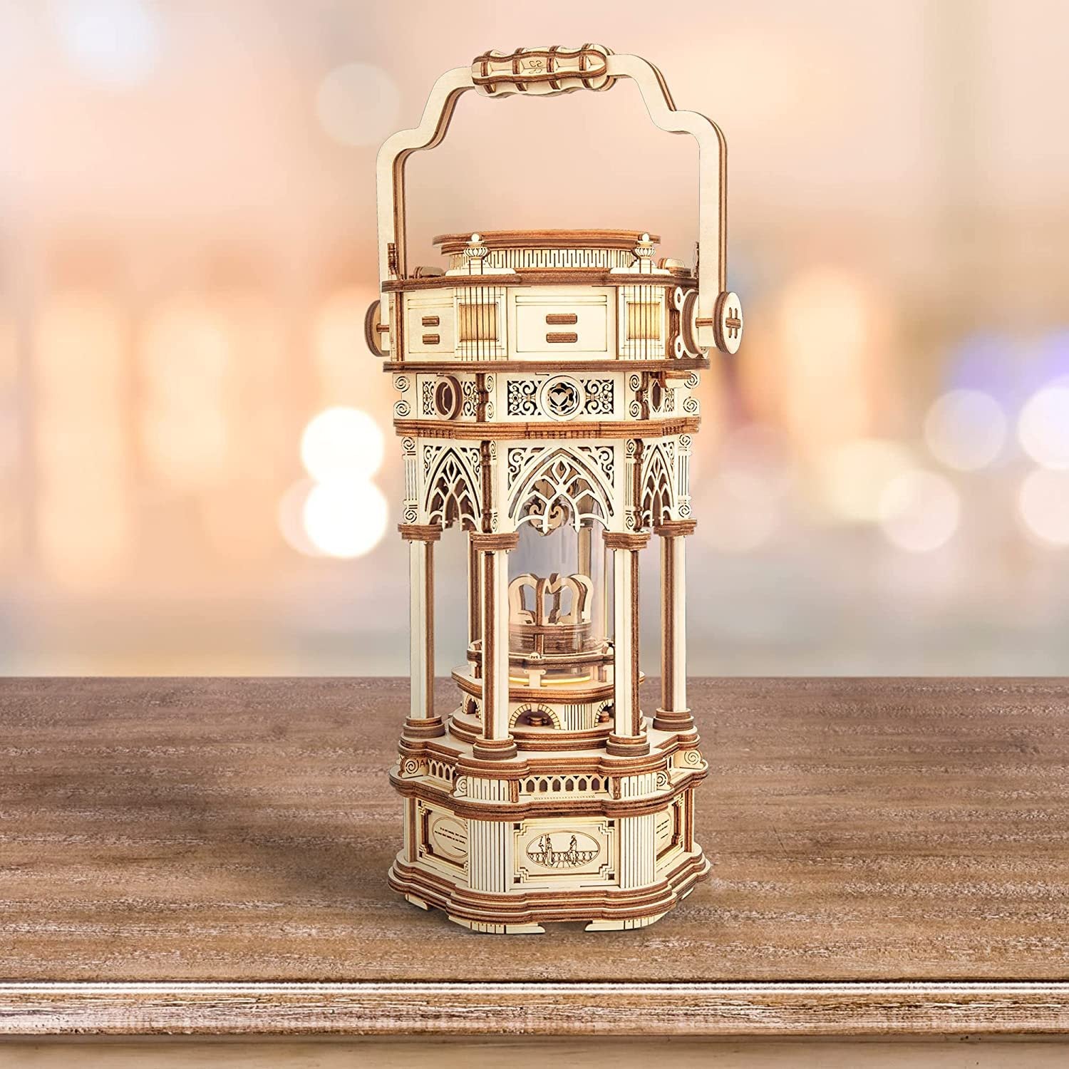 Wooden lantern model on a wooden surface with a blurred light background