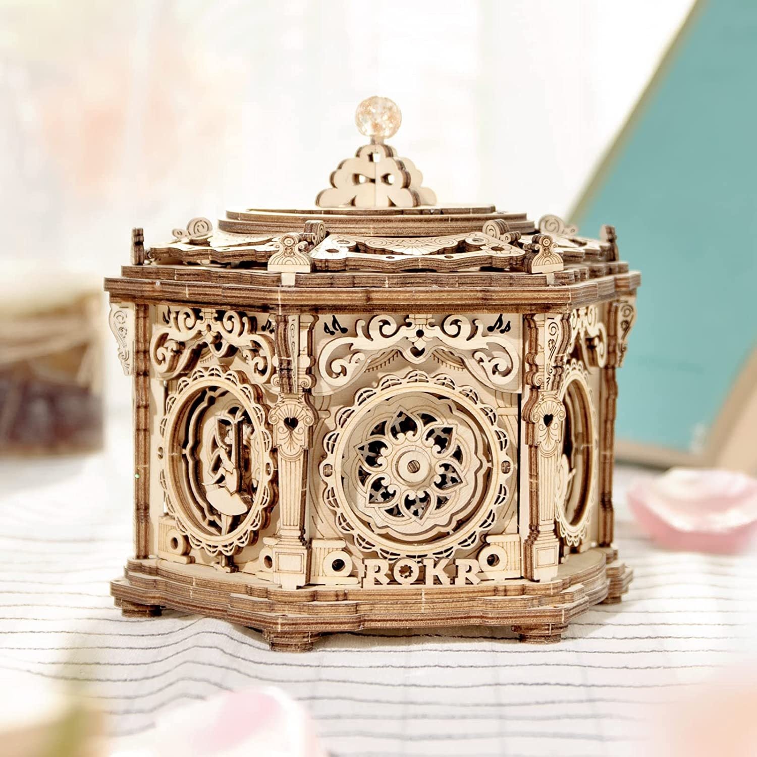 Wooden mechanical model with intricate details on a light surface