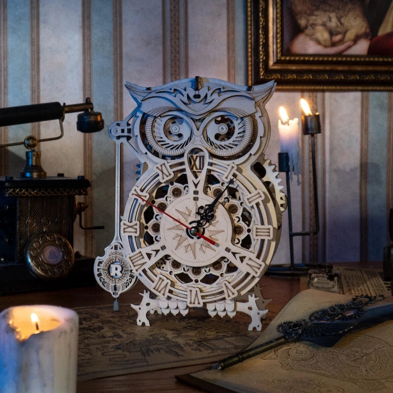 Wooden owl clock with mechanical design on a table with candles and a painting in the background